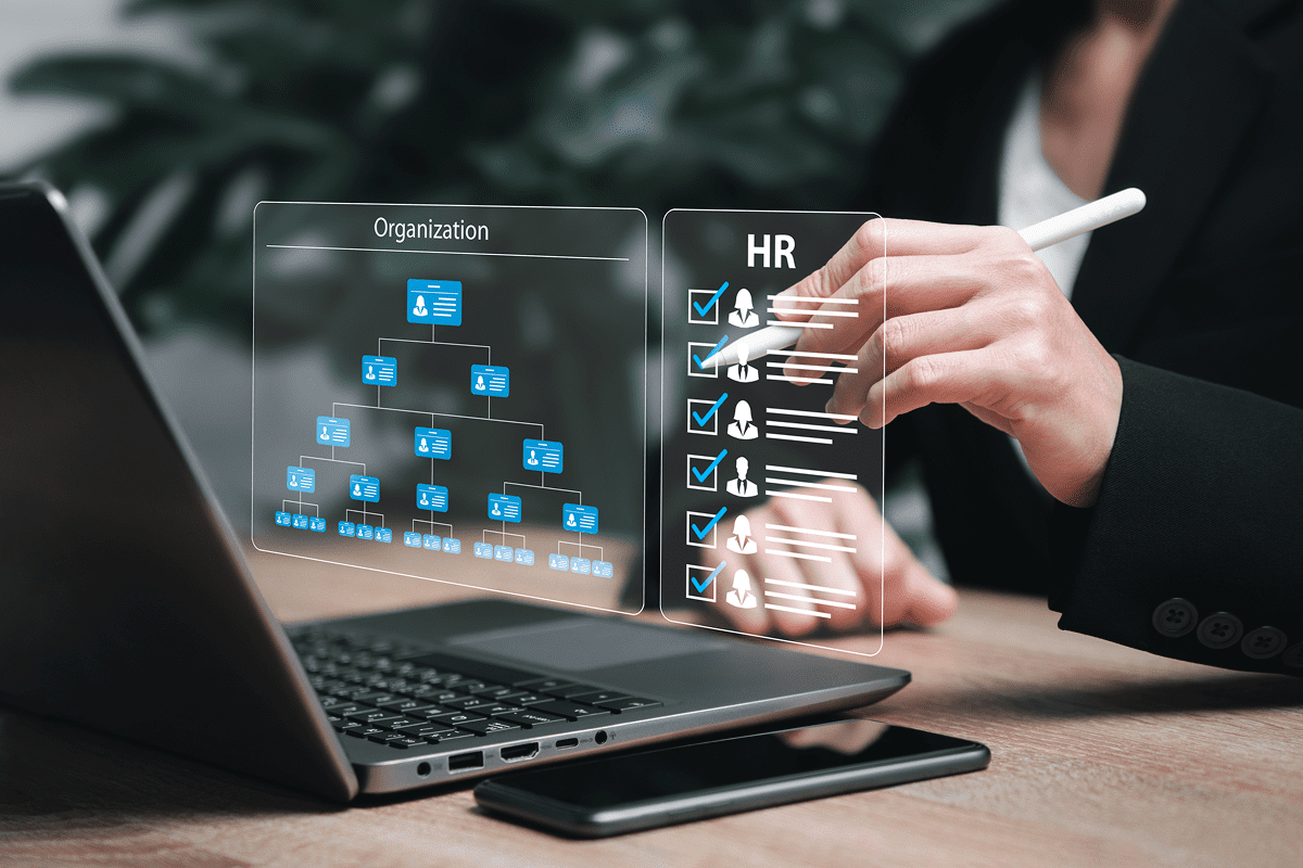Digital HR organizational chart projected over laptop