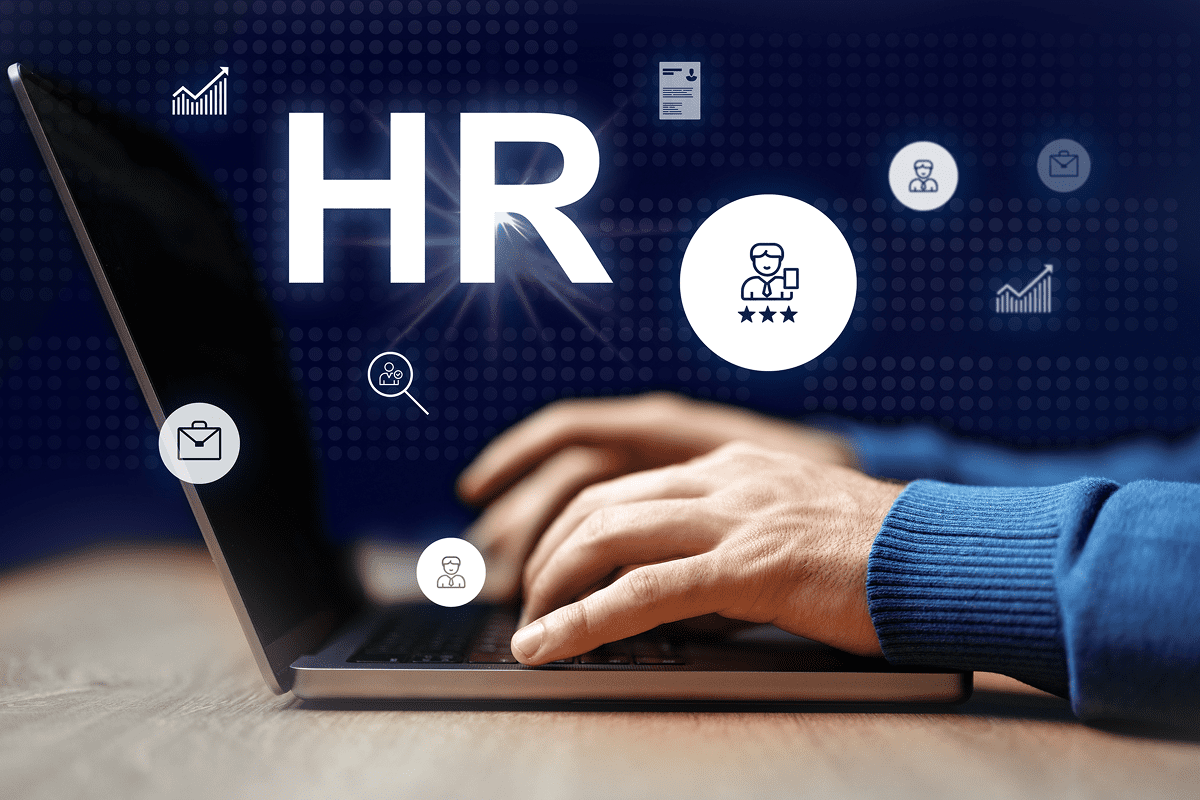 Hands typing on laptop with HR icons