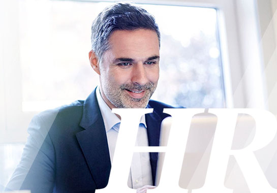 Man smiling while working on laptop